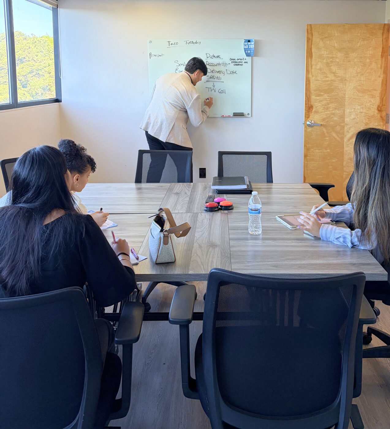 Risin Enterprises team in a conference room strategy meeting
