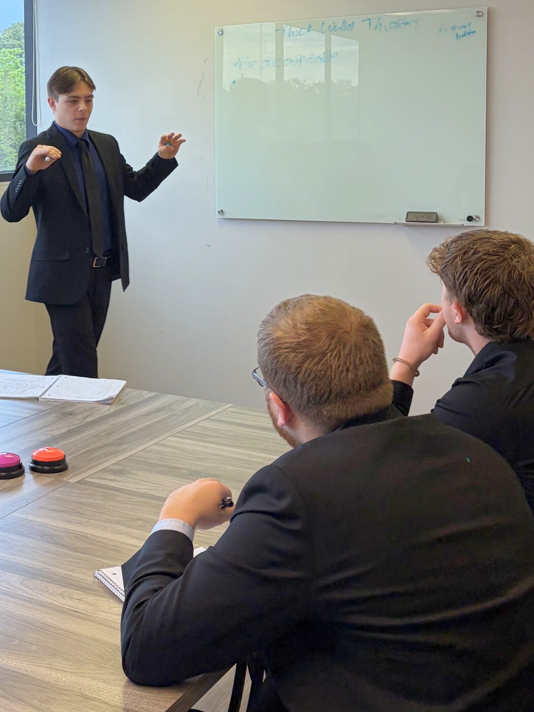 Risin Enterprises team member leading a whiteboard training session