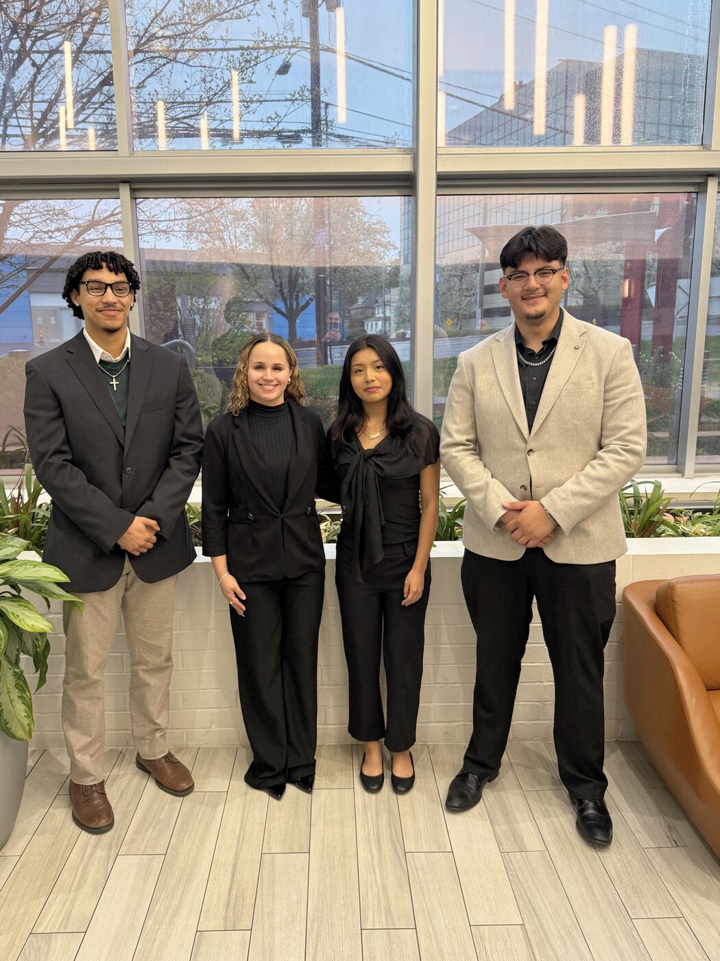 Risin Enterprises team members in business attire at the office